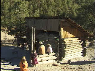 Melina's family in front of their one-bedroom cabin