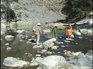 Melina and her family crossing the river